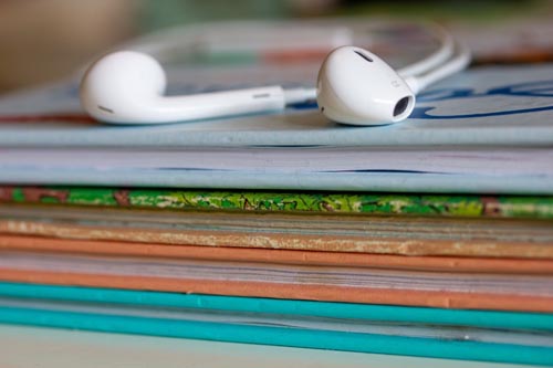 Books with Ear Buds to Represent Listening to Audiobooks for Audiobook Narration Content